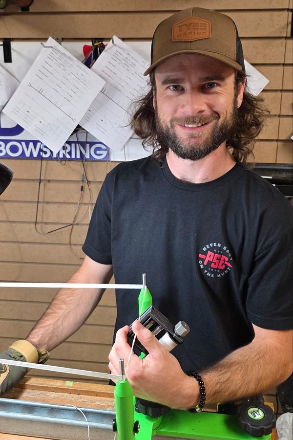 Alex Keith, head builder, serving a bowstring at the bench